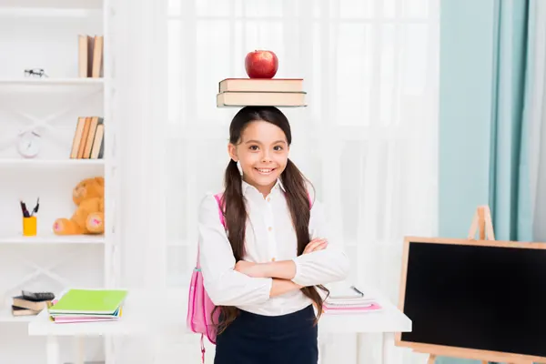 young-schoolgirl-uniform-standing-arms-crossed-classroom