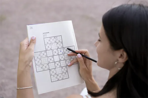 person-playing-sudoku-game-alone